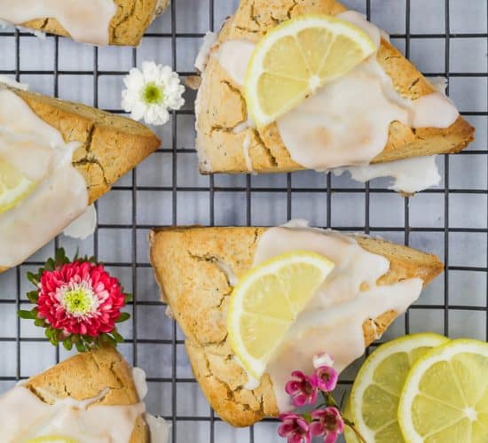 gluten free lemon poppy seed scones with a lemon glaze and lemon slice on top