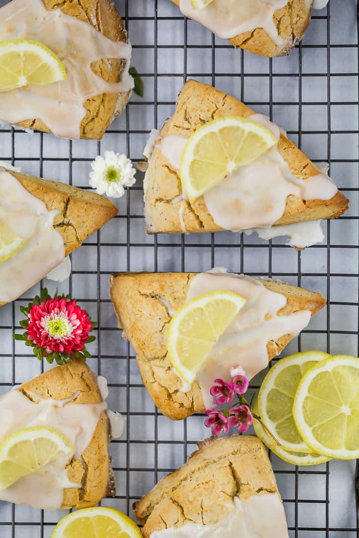 gluten free lemon poppy seed scones with a lemon glaze and lemon slice on top