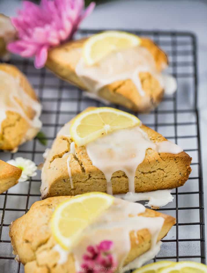 close up side photo of gluten free lemon poppy seed scones with a lemon glaze on top