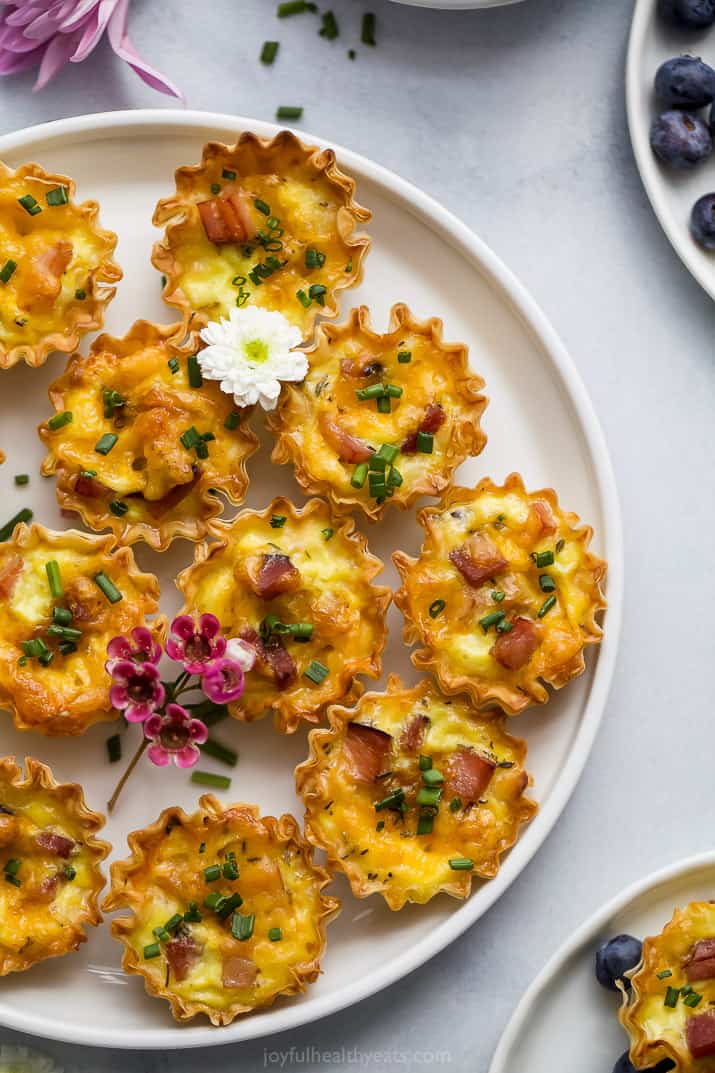 ham and cheese mini quiches topped with chives on a plate