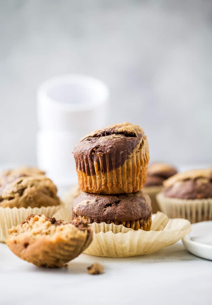 a countertop of muffins that are marbled with chocolate and banana flavors