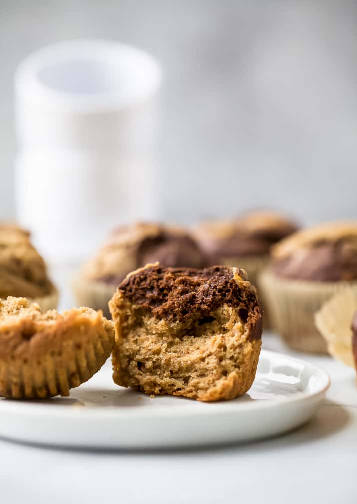 a moist healthy marbled chocolate banana muffin with a bite taken out of it