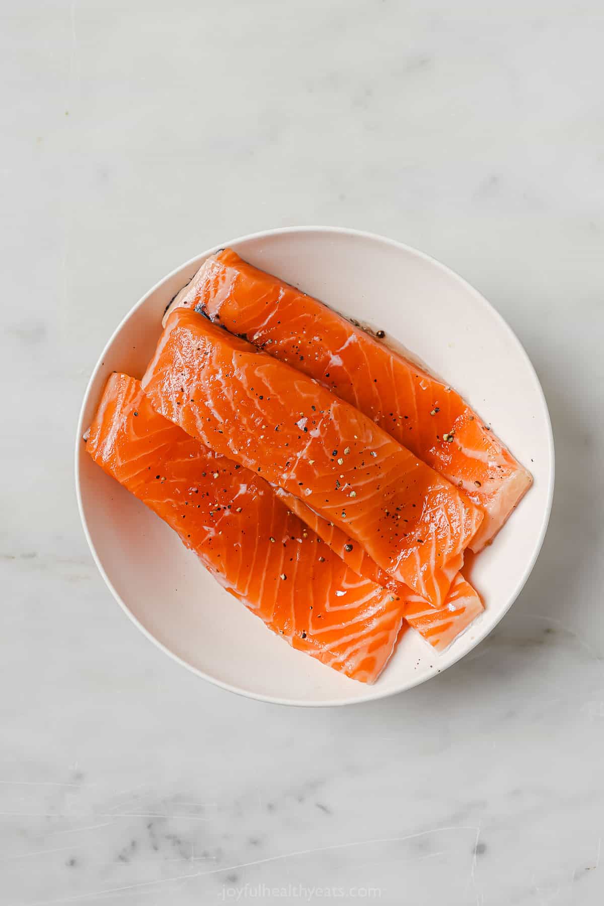Fresh salmon filets in a bowl. 