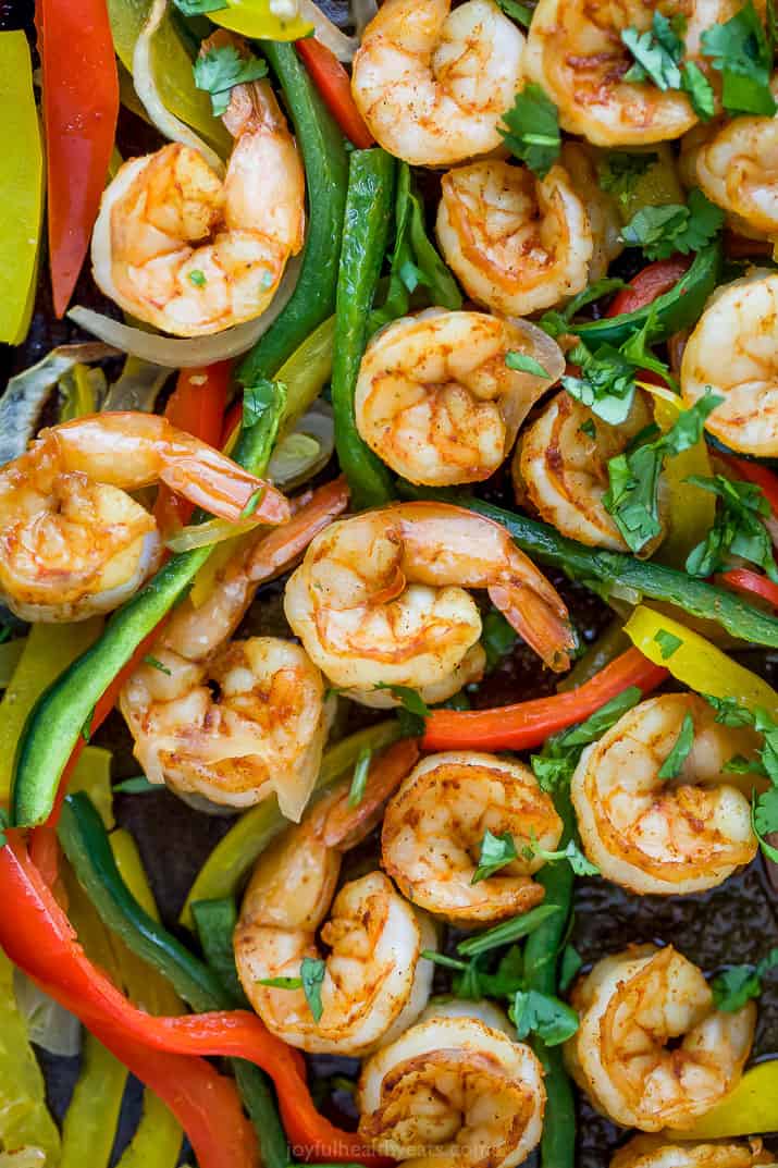 close up photo of sheet pan shrimp fajitas on a baking sheet