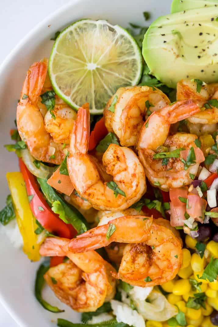 close up of sheet pan shrimp fajitas in a rice bowl