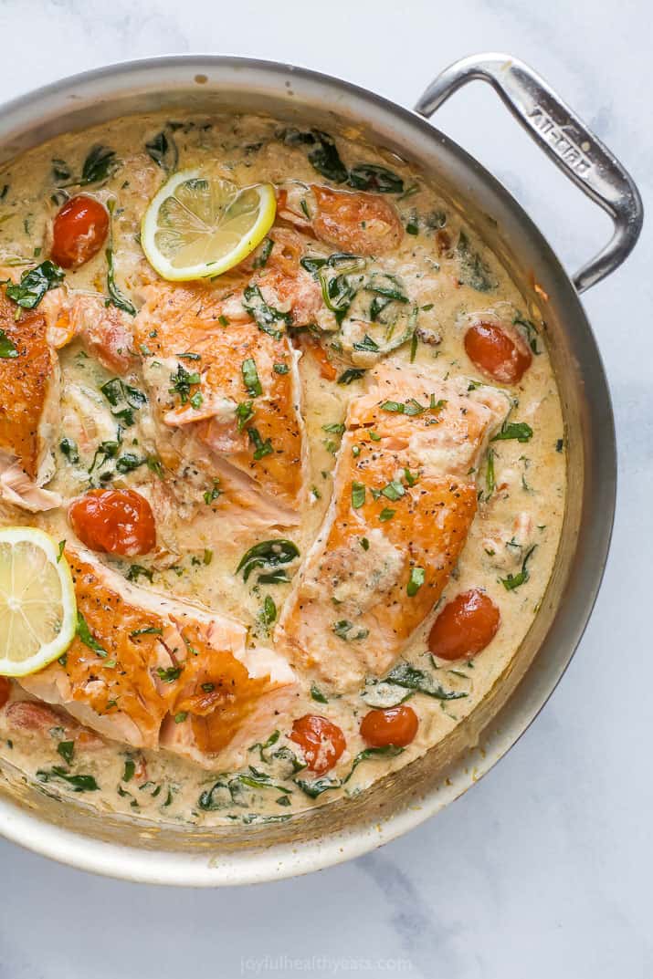 creamy tuscan pan seared salmon in a skillet