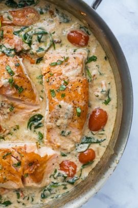 creamy tuscan pan seared salmon in a skillet