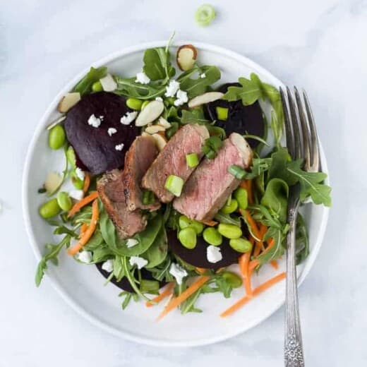 roasted beet steak salad with goat cheese and almonds on a plate