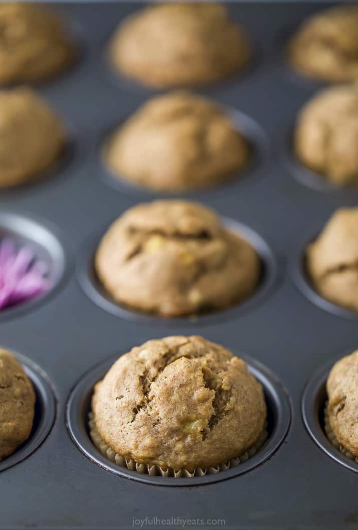 A close-up shot of banana muffins resting in a metal cupcake pan