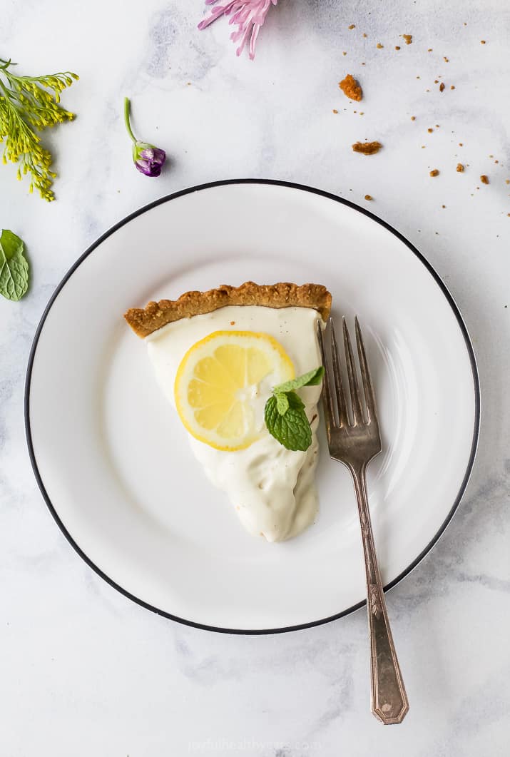 Creamy Lemon Tart Recipe with Almond Crust on a plate with a fork