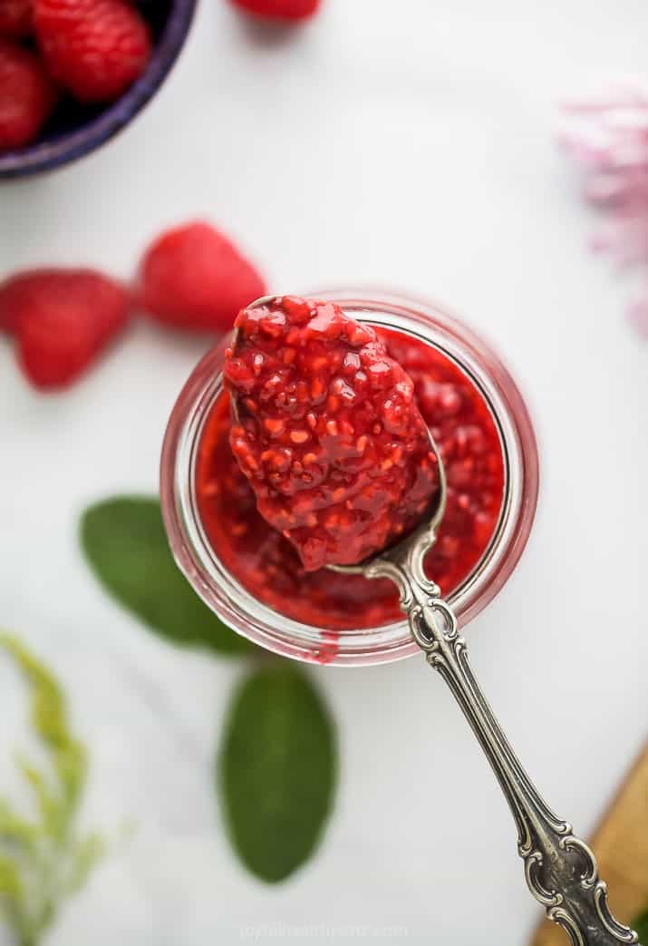overhead photo of Homemade Raspberry Jam Recipew with a spoon full of jam