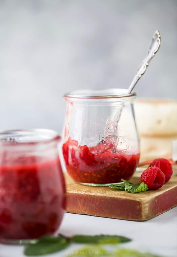 side photo of a half empty jar Homemade Raspberry Jam Recipe