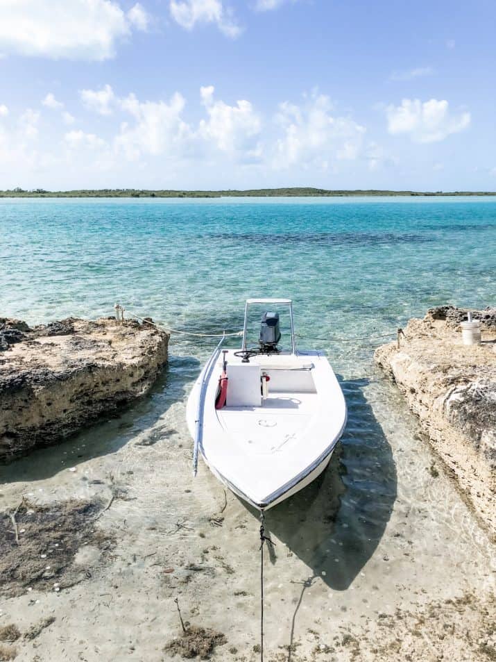 photo of a boat in aqua blue bahamas water