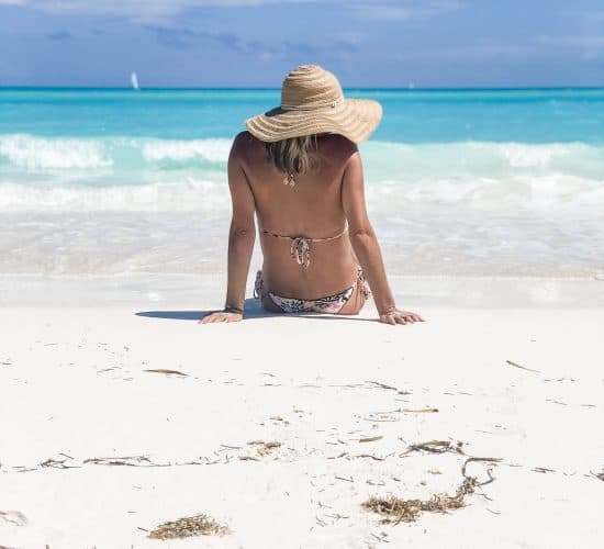 picture of a girl on a the beach with a hat