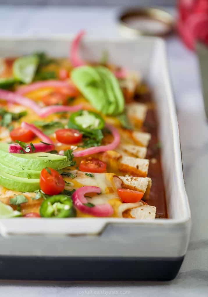 side photo of The Ultimate Ground Beef Enchilada Recipe with toppings on top