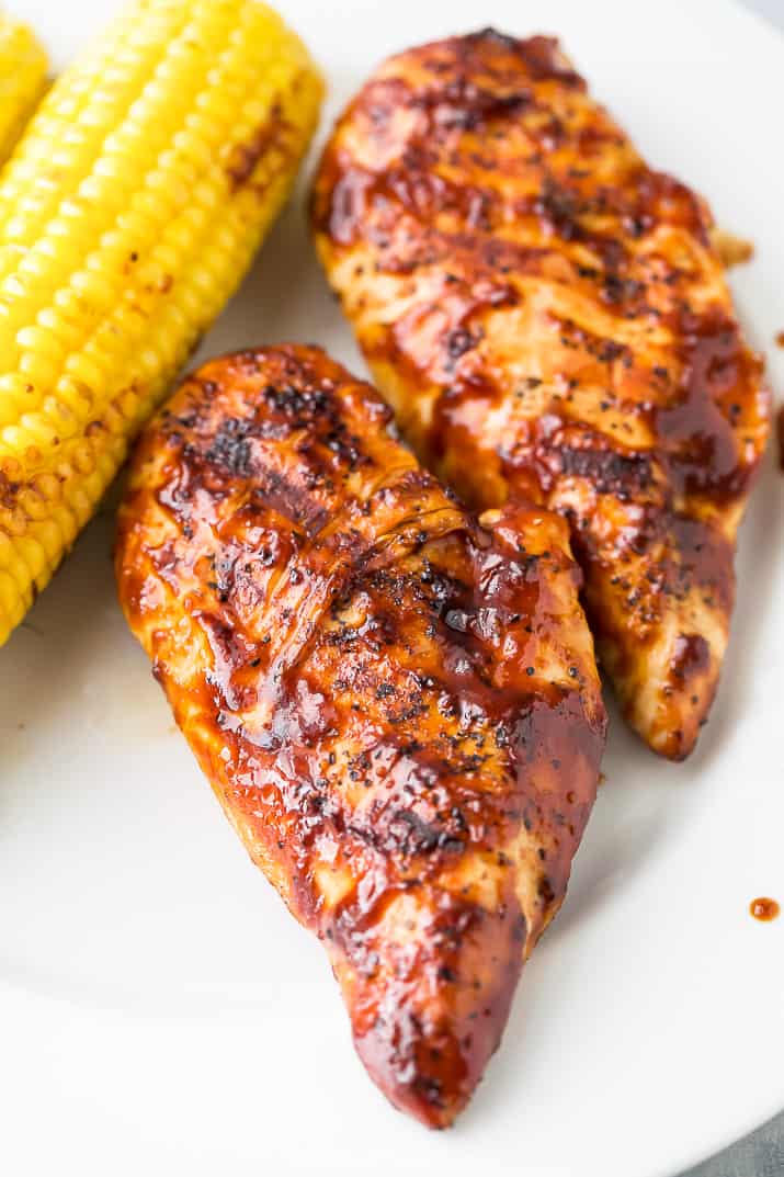 close up photo of grilled BBQ Chicken on a plate with grilled corn