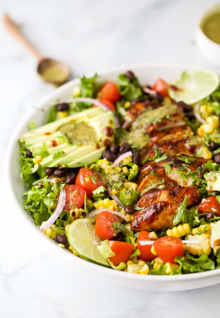 side photo of 30 minute BBQ Chicken Salad in a bowl with cilantro lime dressing on top