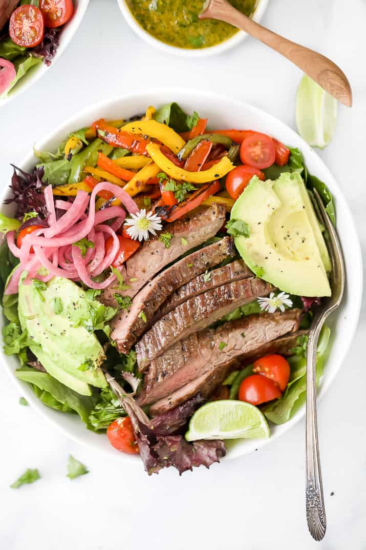 grilled fajita steak salad with chimichurri dressing in a bowl