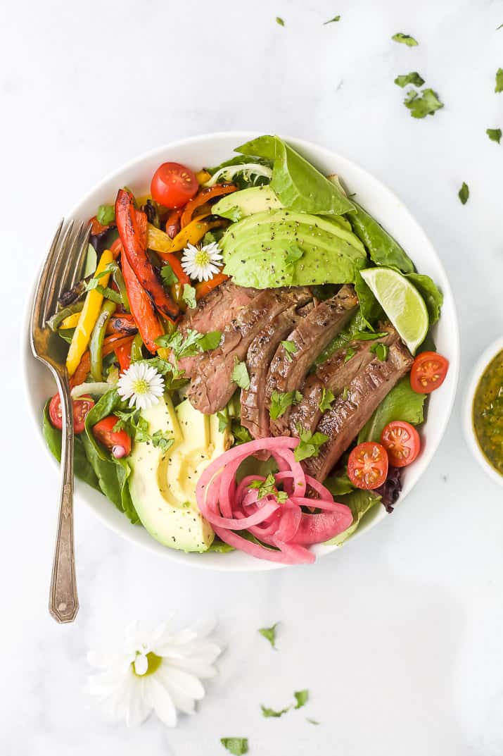 overhead photo of grilled fajita steak salad with chimichurri dressing