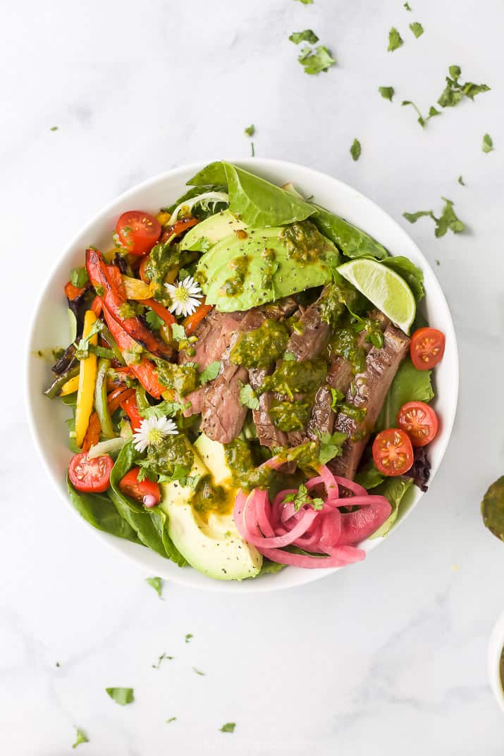 grilled fajita steak salad with chimichurri dressing in a bowl