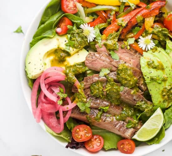 grilled fajita steak salad with chimichurri dressing in a bowl