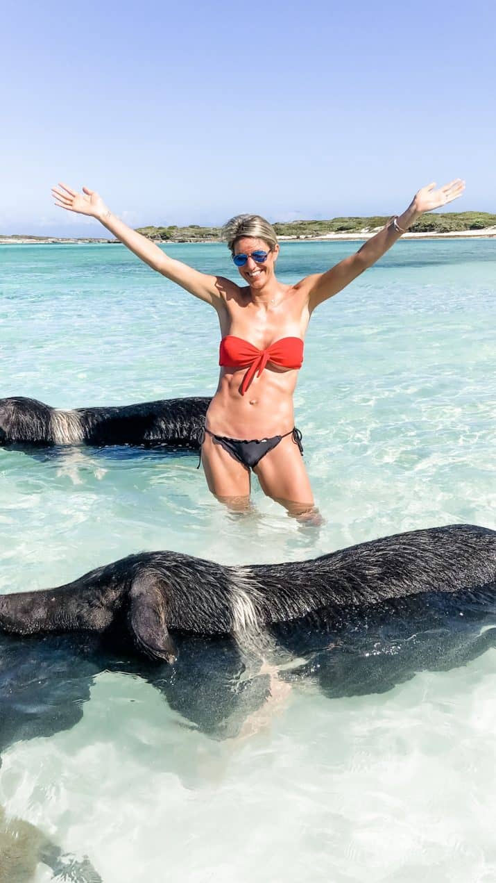 picture of a girl in the middle of swimming pigs