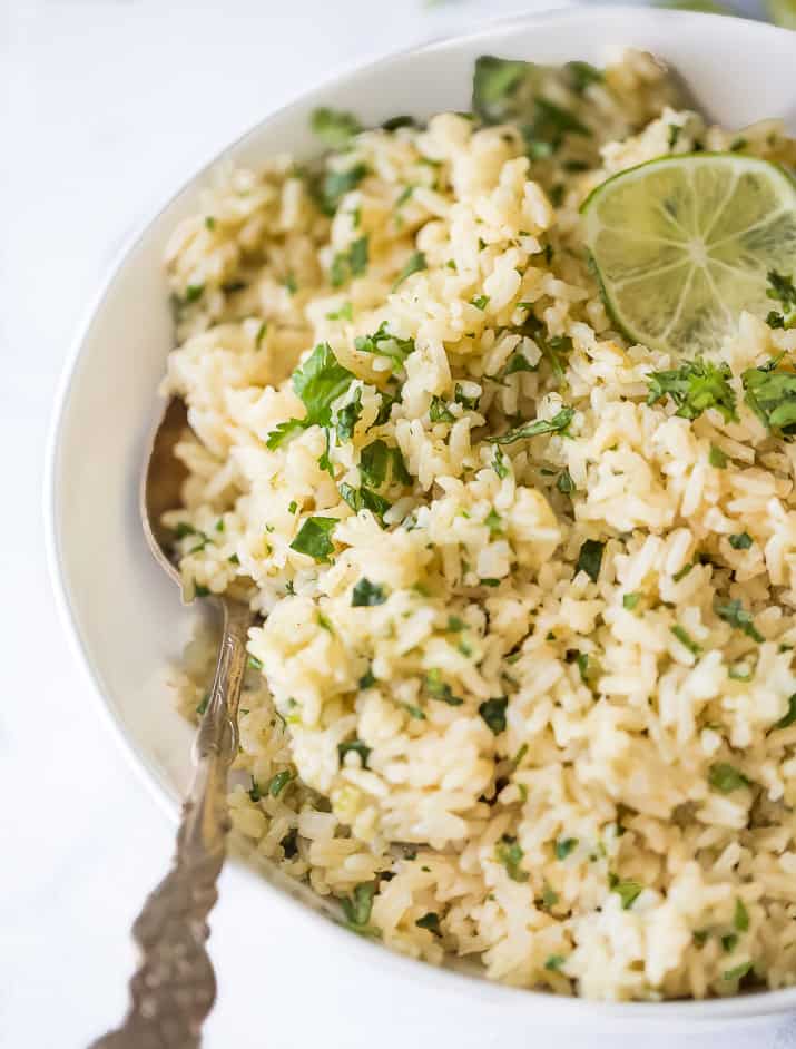 side photo of the best instant pot cilantro lime rice in a bowl with a spoon