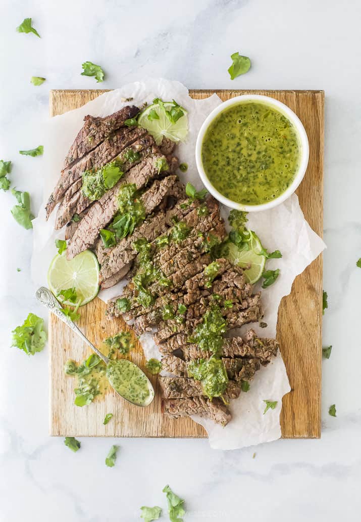 overhead photo of the best marinated grilled flank steak recipe with chimichurri sauce