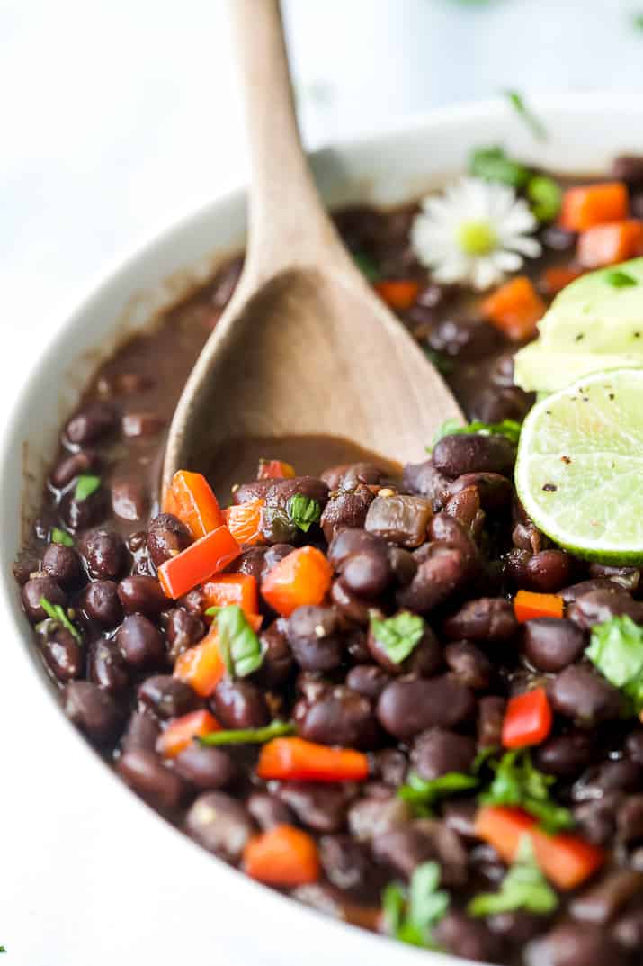 wooden spoon scooping mexican instant pot black beans