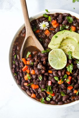 overhead photo of a wooden spoon scooping mexican instant pot black beans
