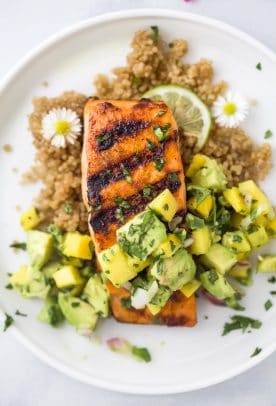 close up overhead photo of easy chili lime grilled salmon with mango avocado salsa on a plate