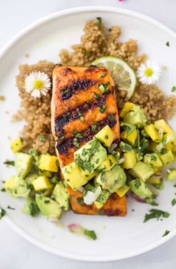 close up overhead photo of easy chili lime grilled salmon with mango avocado salsa on a plate