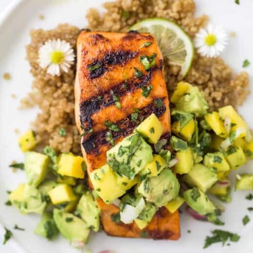 close up overhead photo of easy chili lime grilled salmon with mango avocado salsa on a plate