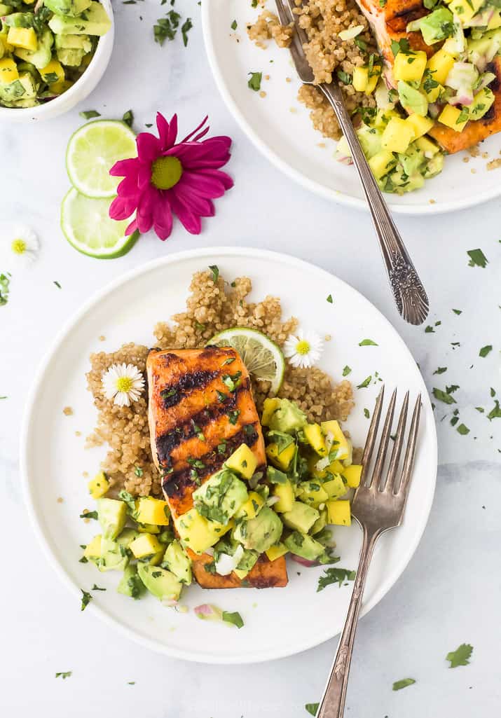 chili lime grilled salmon with mango avocado salsa on a plate with a fork
