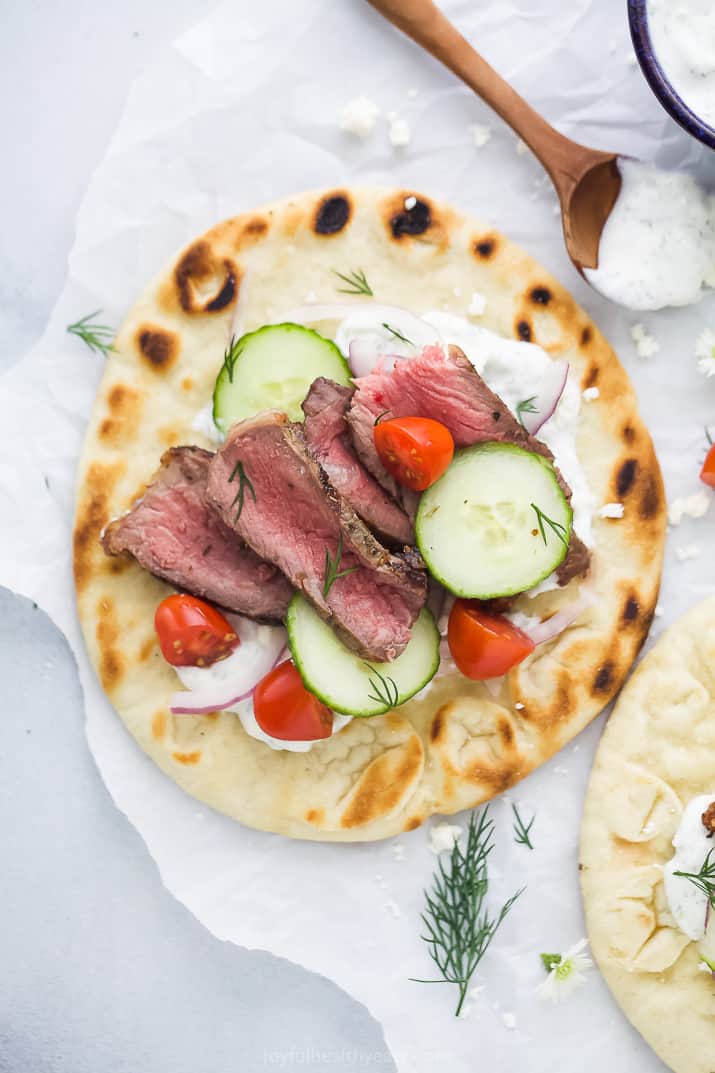 overhead photo of easy grilled steak gyros with tzatziki sauce