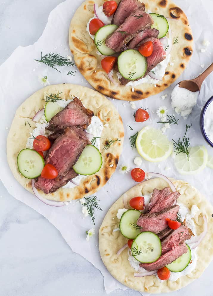 overhead photos of three easy grilled steak gyros with tzatziki sauce