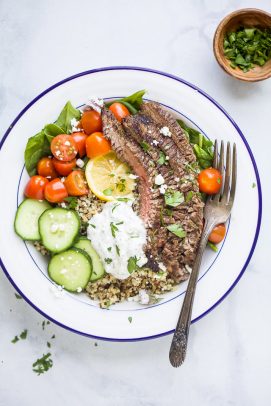 easy mediterranean steak and quinoa bowl topped with tzatziki