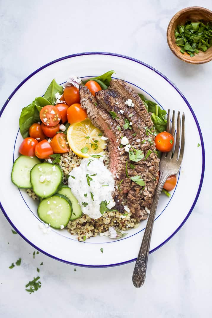 easy mediterranean steak and quinoa bowl topped with tzatziki