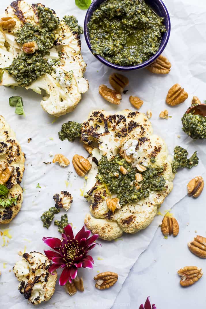 overhead photo of grilled cauliflower steaks with pecan pesto