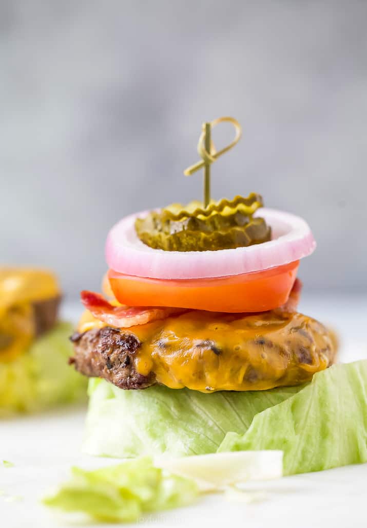 the perfect keto bacon cheeseburger with ground bison meat topped with burger fixings