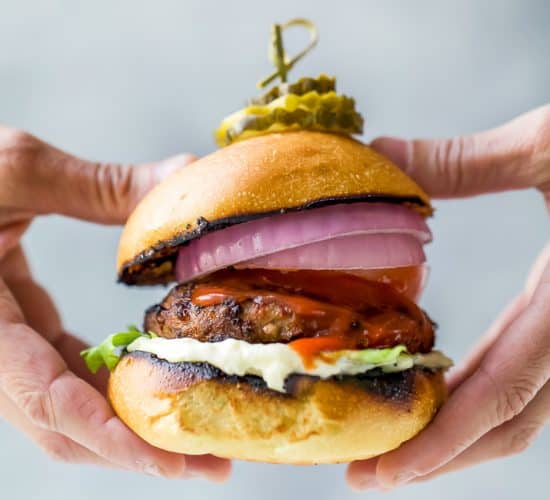 ultimate classic turkey burger being held with hands
