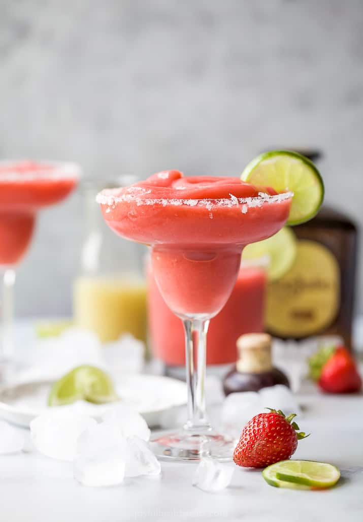 photo of the ultimate blender frozen strawberry margaritas in a glass with a lime