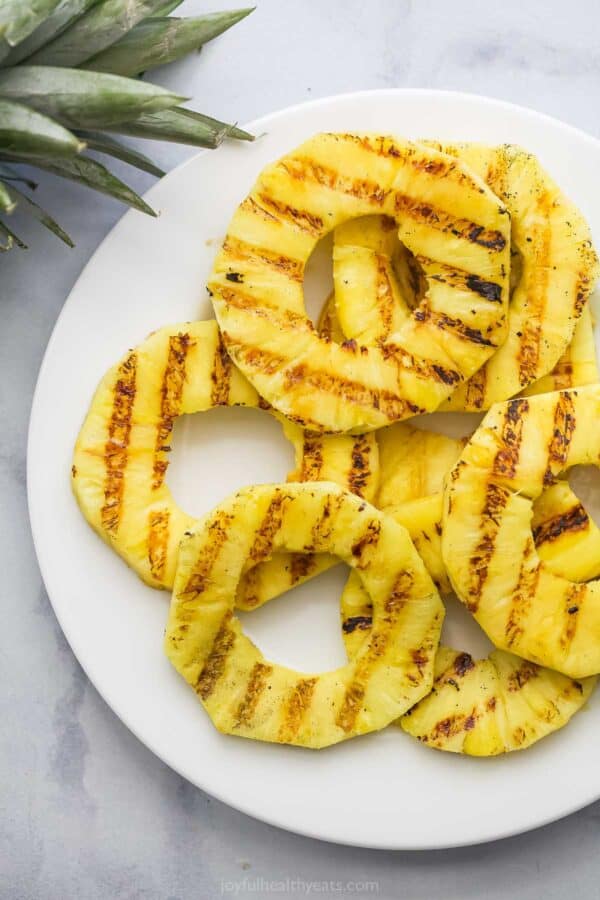 Overhead view of grilled pineapple slices on plate