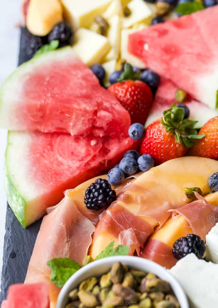 close up of summer fruit and cheese board with watermelon and cantaloupe