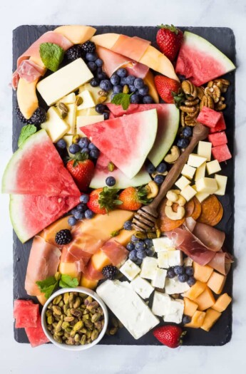 overhead photo of a summer fruit and cheese board