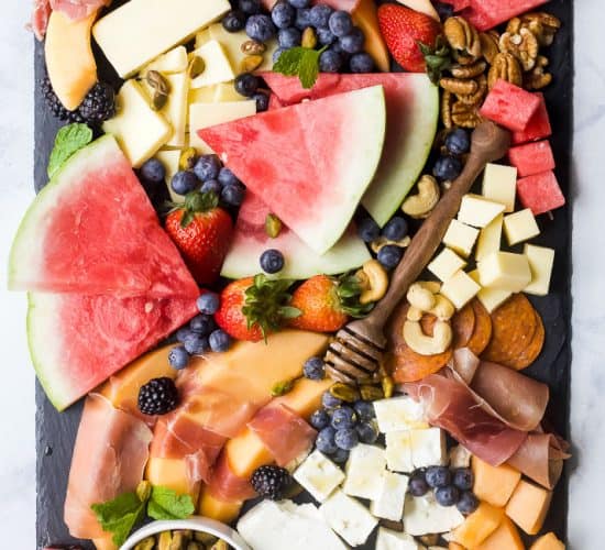 overhead photo of a summer fruit and cheese board