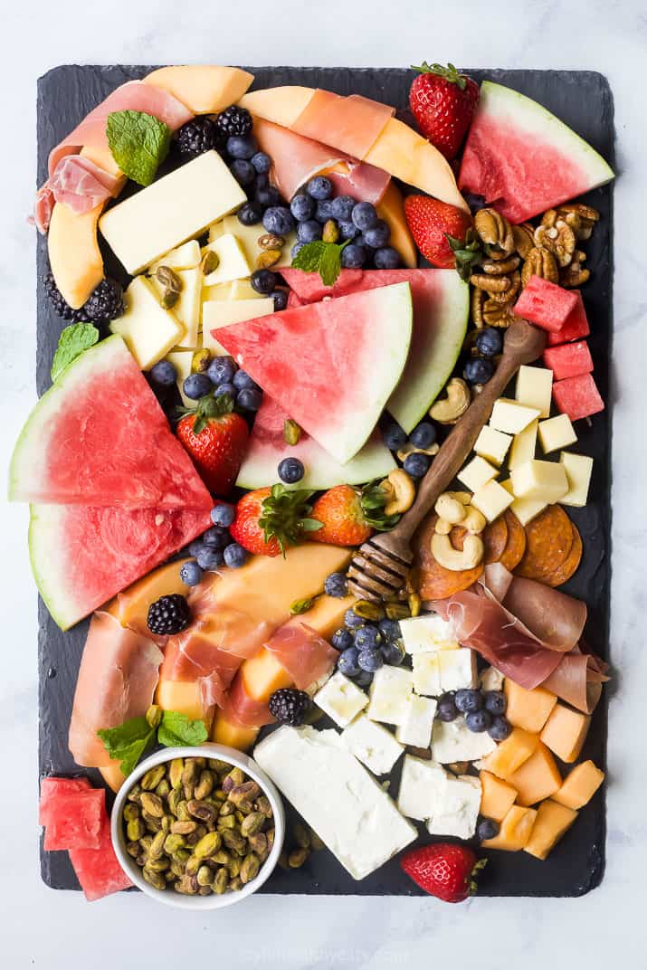 overhead photo of a summer fruit and cheese board