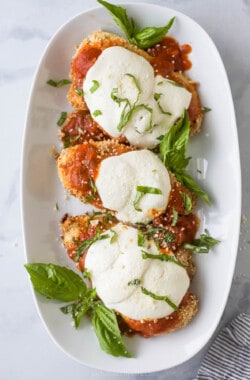 Three pieces of chicken parm on a plate.