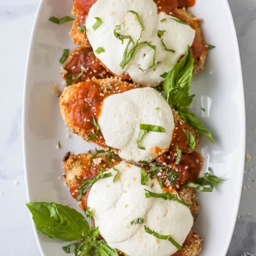 Three pieces of chicken parm on a plate.