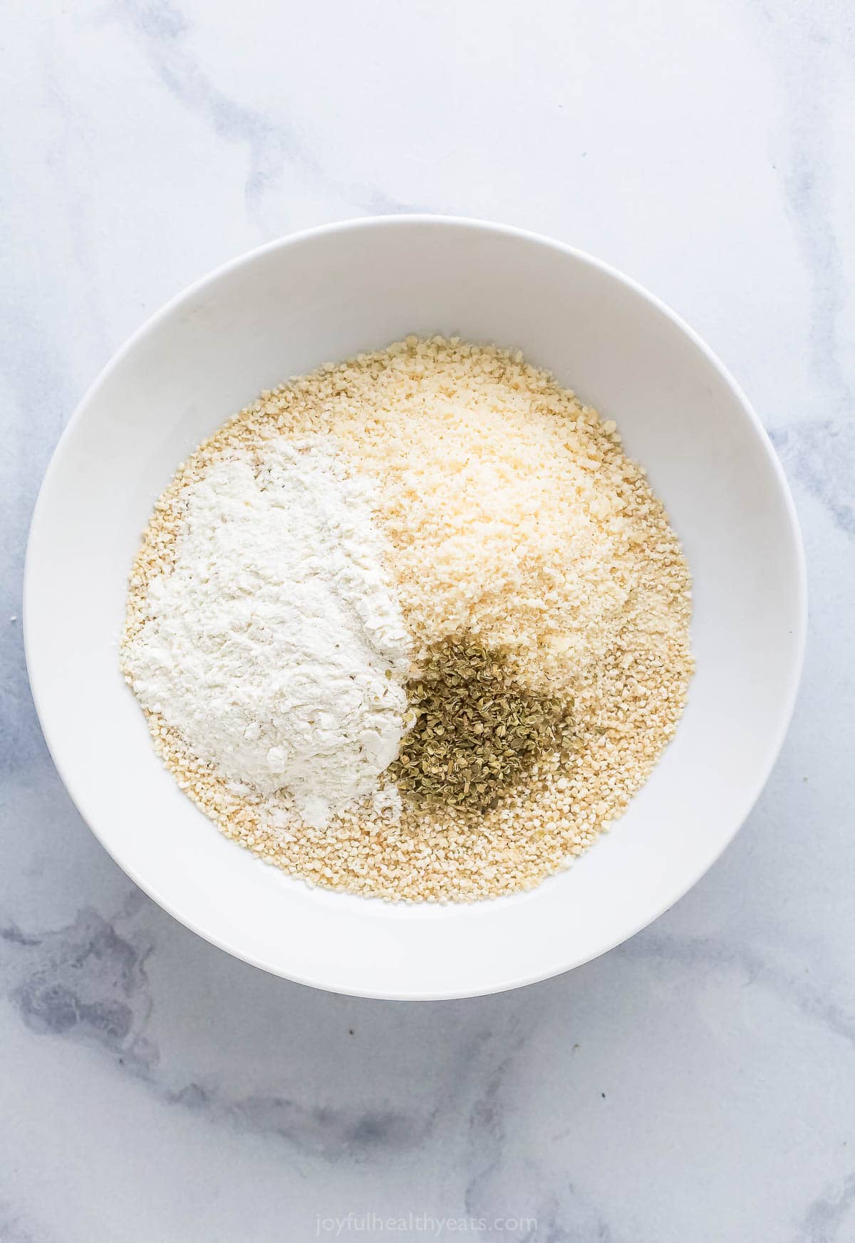 Adding the breading ingredients to a bowl. 